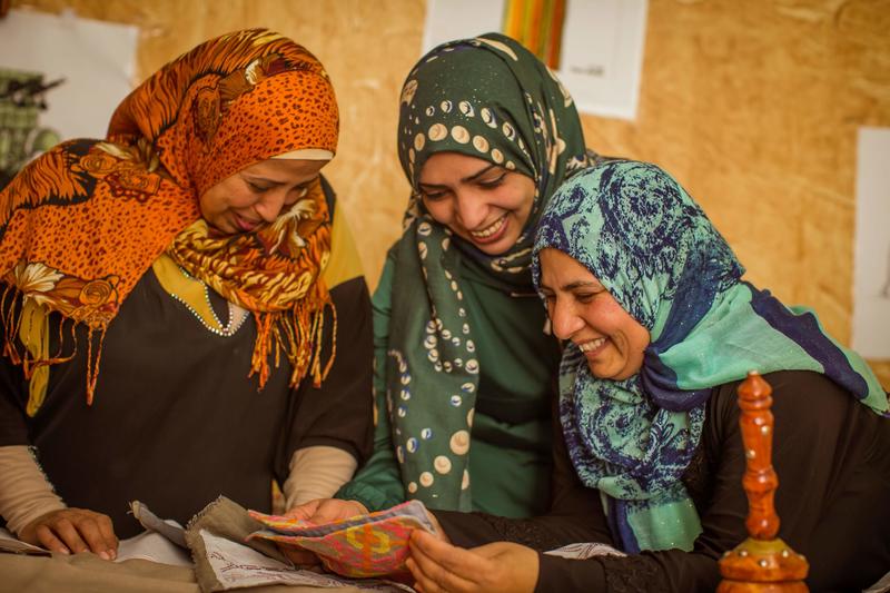 Syrian refugee artisans reviewing a new design.