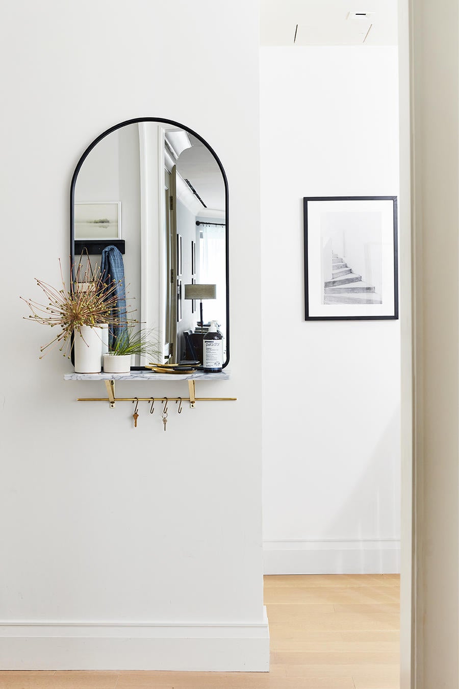 In the era of COVID, the entryway in the Real Simple House a bottle of hand sanitizer perched under the mirror.