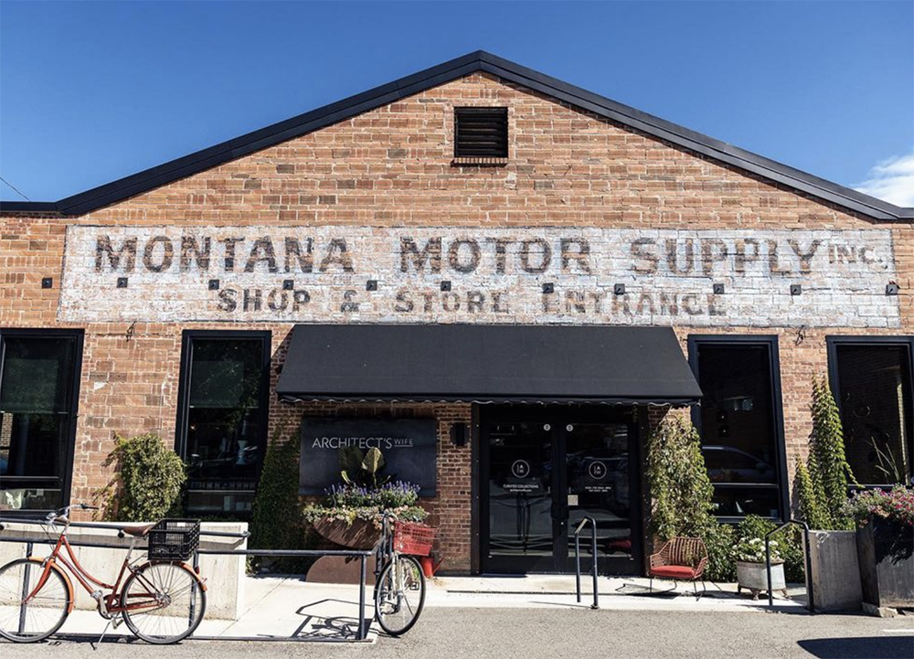 The location was a motor shop before it was converted into retails space. It still features the steel braces, wood rafters, brick walls, and concrete floors from its previous life