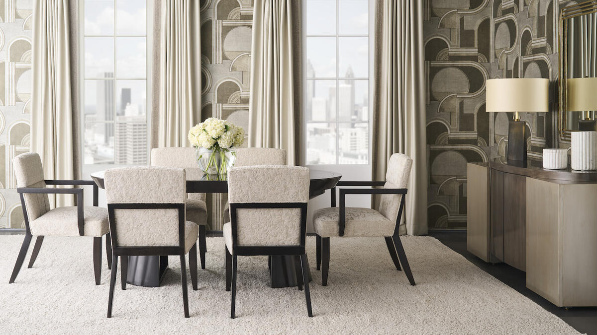 Donghia’s Metropolis wallcovering in Bronze serves as a dramatic backdrop for Kravet’s Collins dining table and Dade chairs 