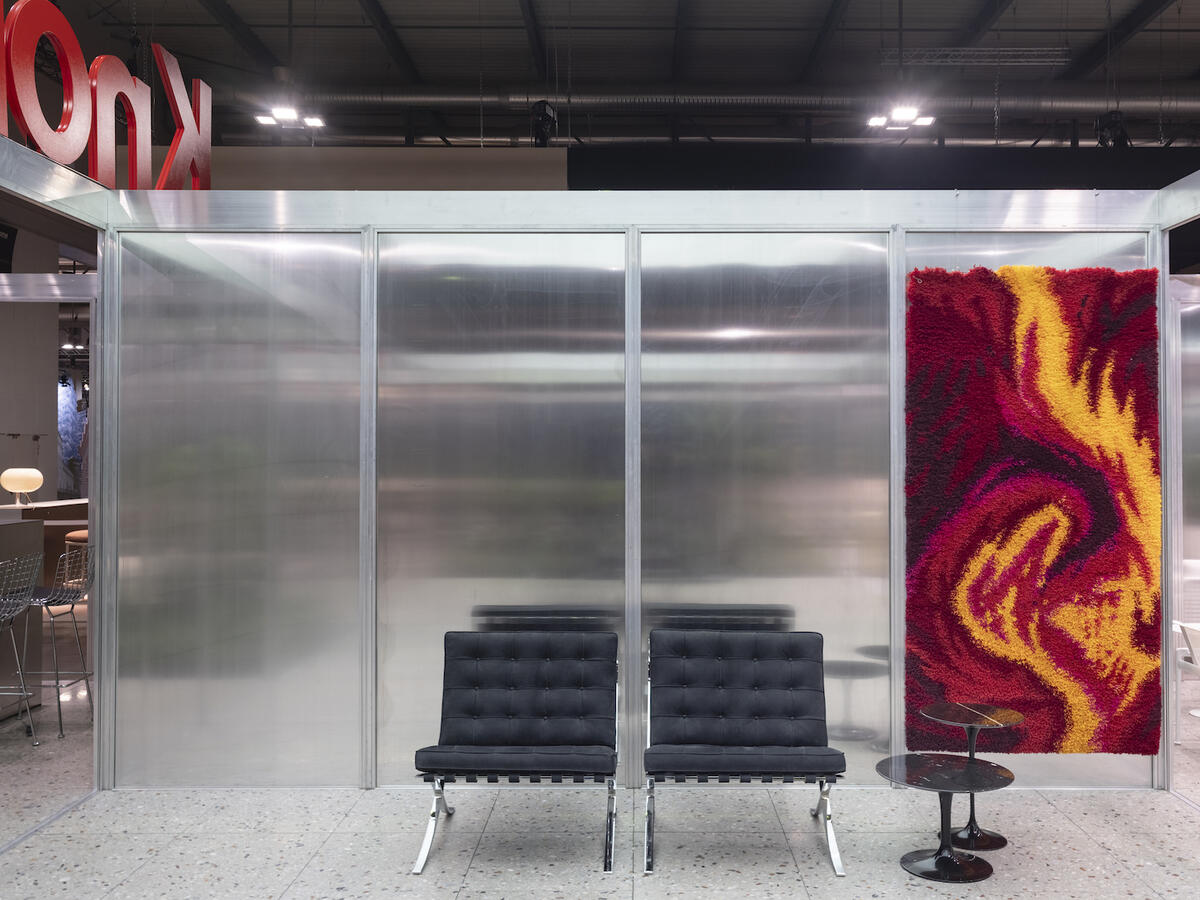 A scene from the Knoll pavilion at Salone del Mobile, featuring Barcelona chairs by Ludwig Mies van der Rohe and a rug by Sleepwalk Rug Company 