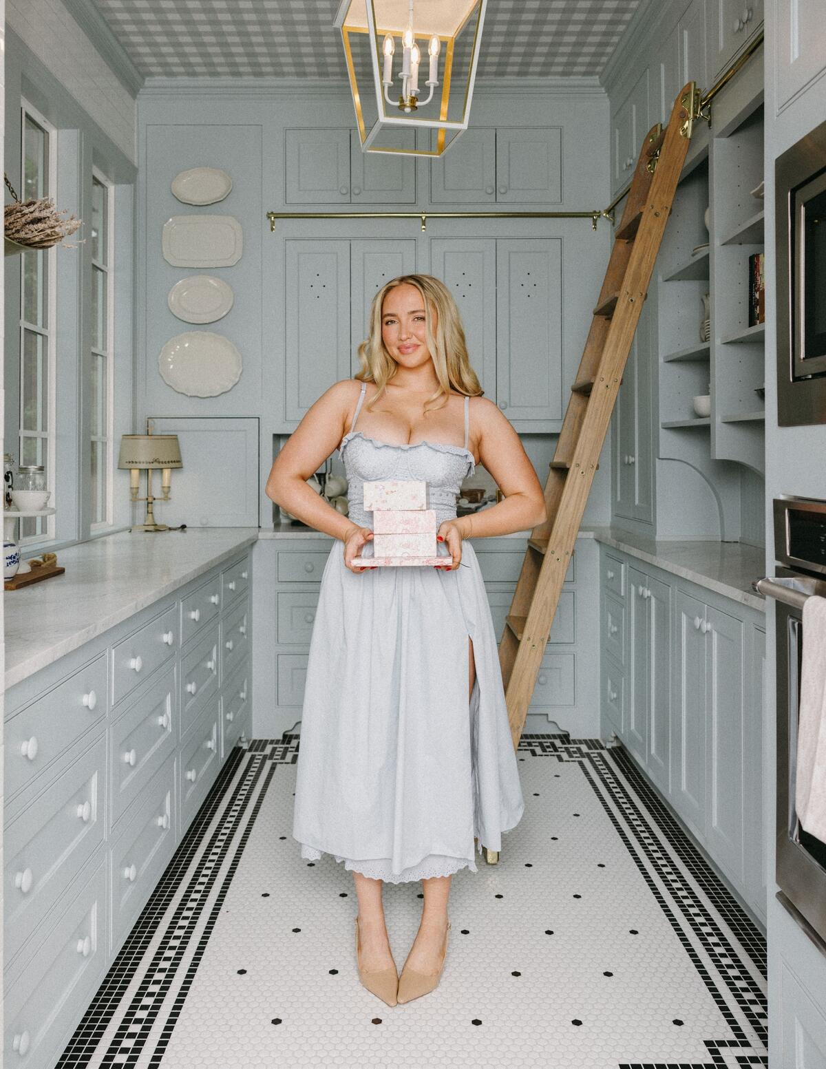Kenzie Elizabeth, who calls herself a Gen Z Martha Stewart, posing in her Texas kitchen
