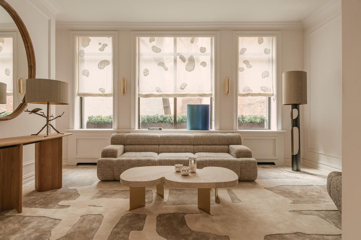 A scene from inside The Invisible Collection’s New York townhouse gallery, including the Mekah sofa, Icarus coffee table and R12 floor lamp by Thierry Lemaire 