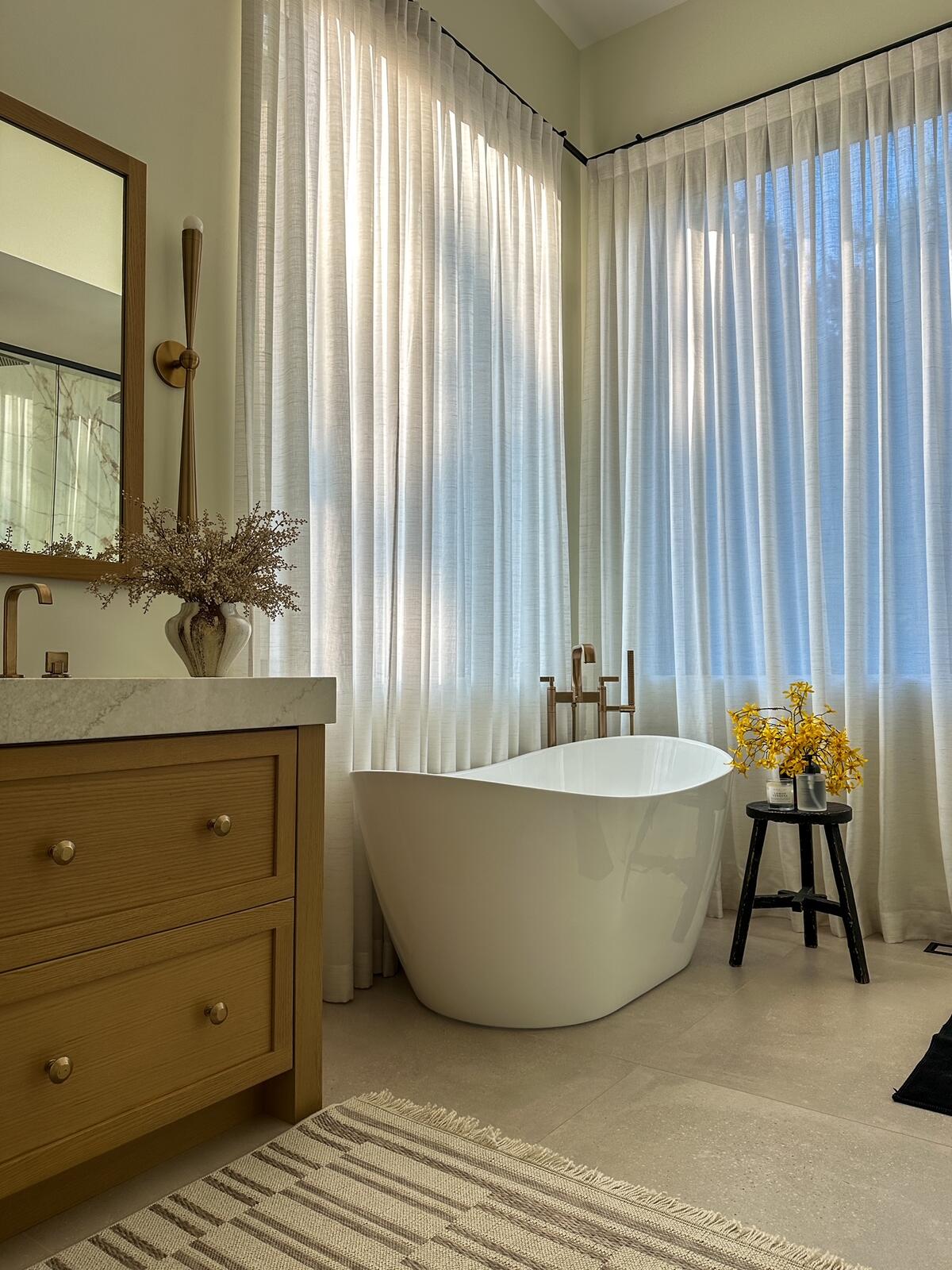 Bronze accents pop in this sun-drenched bathroom 