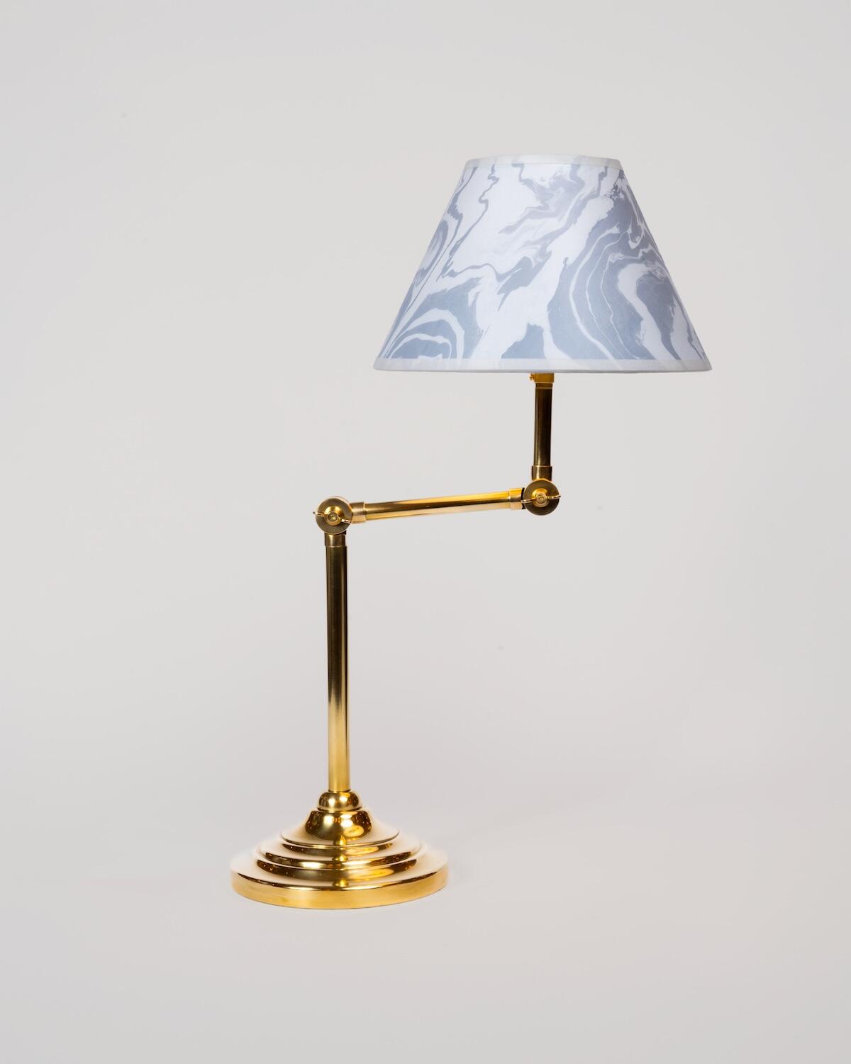 The Buckton desk lamp is shown with a lampshade in Calico’s Sumi pattern in Salt 