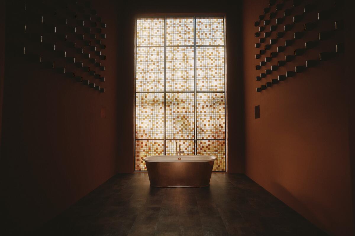 The Flamingo Estate Bathhouse by Kohler, featuring the Reverie freestanding bath