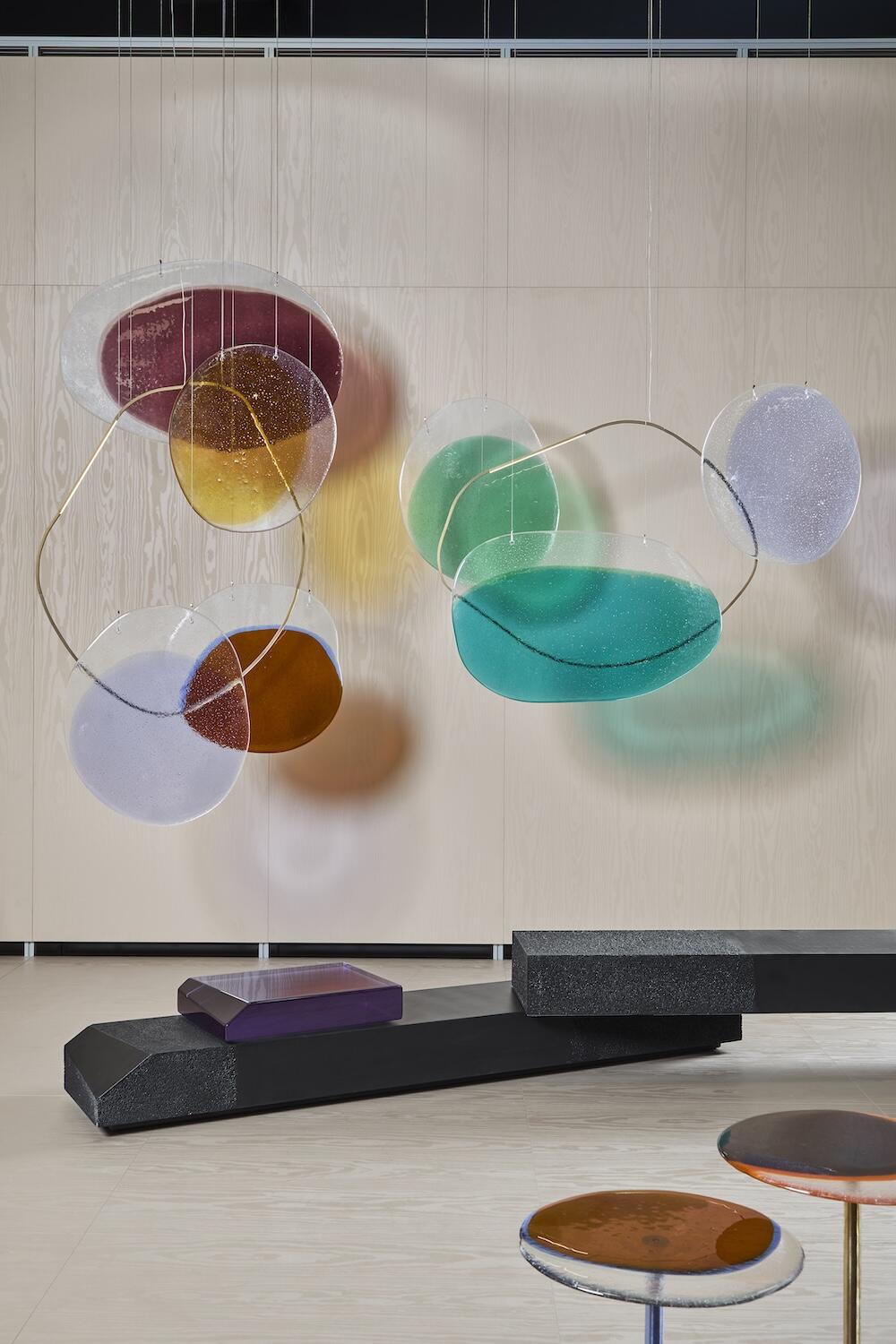 A scene from Salone Raritas, including Draga & Aurel’s Crisalide suspension light and Rive duo bench by Salviati
