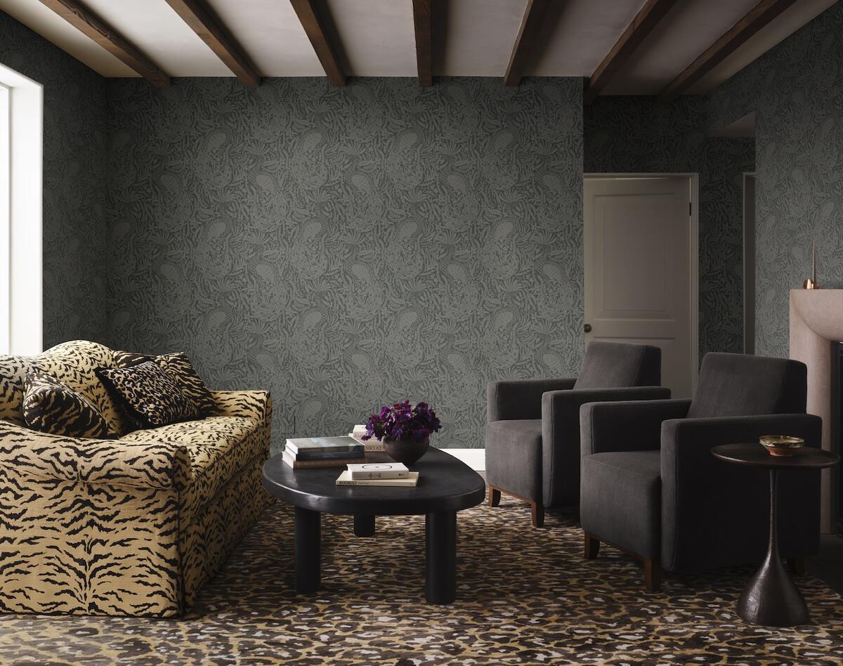 Selections from the Ken Fulk x Perennials collection, including the Fine Feathered Friend wallcovering in Noir and a sofa upholstered in Wild Bengal fabric in Golden