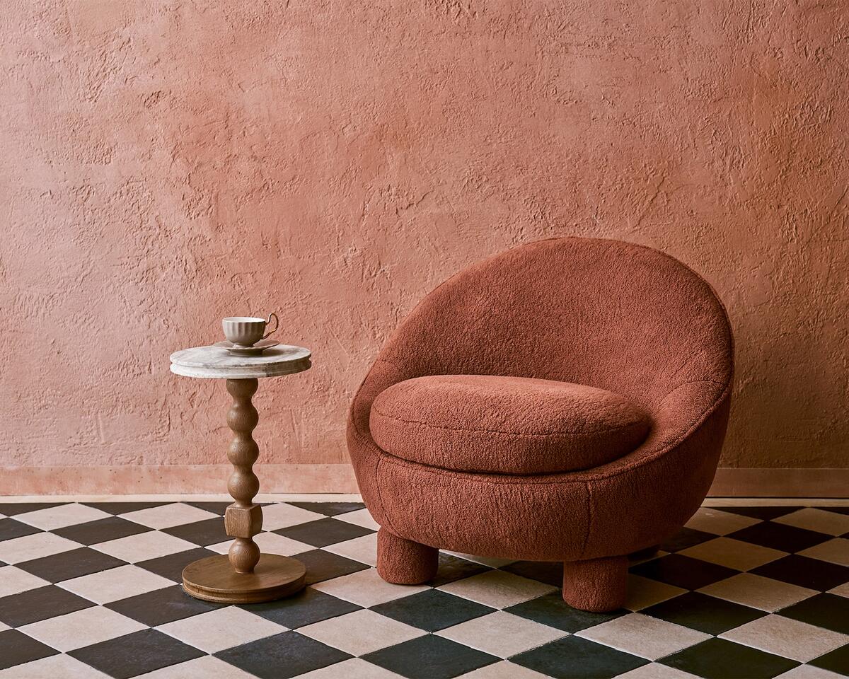 The Rumi chair in Rust and the Tarin drink table by Tan France for Castlery 