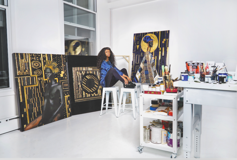Lina Iris Viktor seated in her studio in 2015, surrounded by works that call to mind historical references from the Vienna Secession to Afrofuturism. Photo by Lina Iris Viktor; courtesy of the artist. 