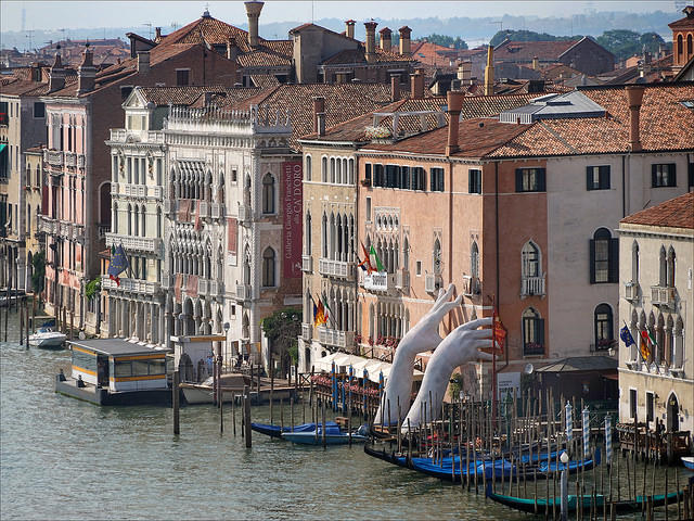 Lorenzo Quinn's "Support" sculpture at the Grand Canal in Venice, Italy at last year's Biennale; photo by JEAN-PIERRE DALBÉRA