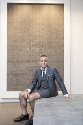 Thom Browne in front of the Cable Knit Grey rug