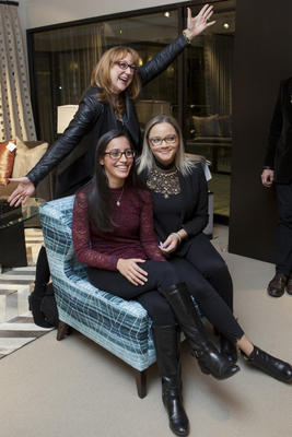 Two members of the winning team, NYIT students Victoria Rouse and Destiny Bates, pose with their mentor, Robin Baron, on the chair upholstered in the fabric they designed. (Not pictured: team member John Sanchez)