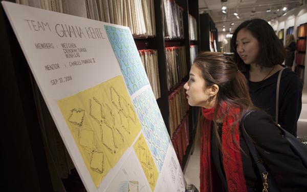 NYSID MFA student Minh Lai and SVA student Wei Chen check out their design board.