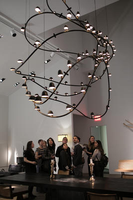 The group admires the larger-than-life fixture by Frederik Molenschot.