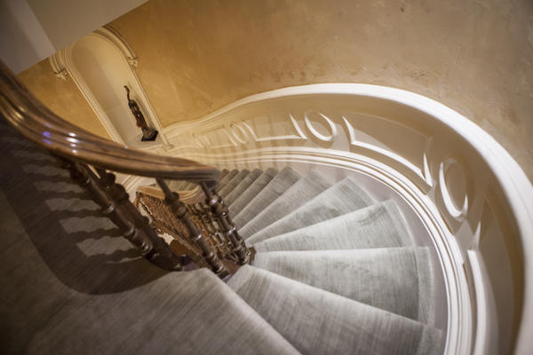 The swooping and intricately carved staircase