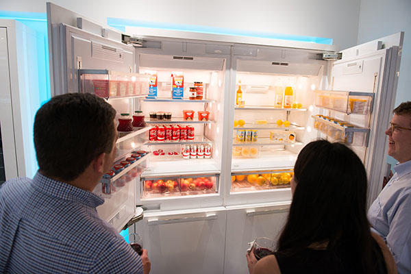 Attendees looking at a refrigerator