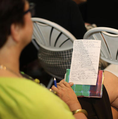 An attendee takes notes during the discussion