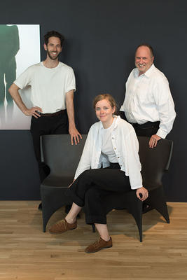 Parsons students Gregory Benson and Sarah Burns pose with Bruce Bierman on Patrick Naggar’s seating. 