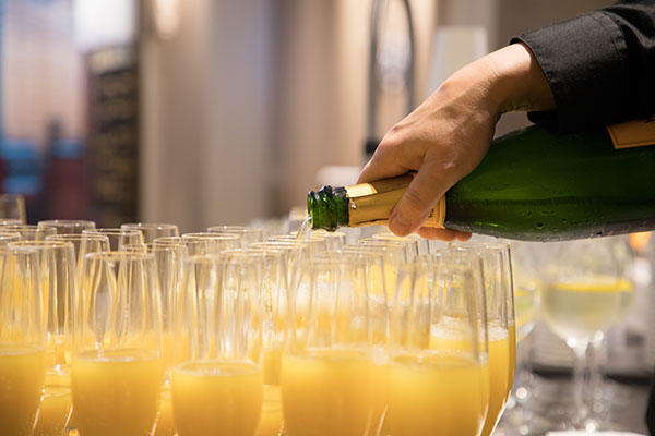 Mimosas being poured for guests