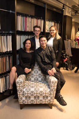 The winning team: students Destiny Bates of NYIT, Connor Lucas of Parsons, Paul Lee of NYSID, and their mentor, Jan Jernoske of Transitional Interiors posing with their winning design upholstered on the Kravet armchair 
