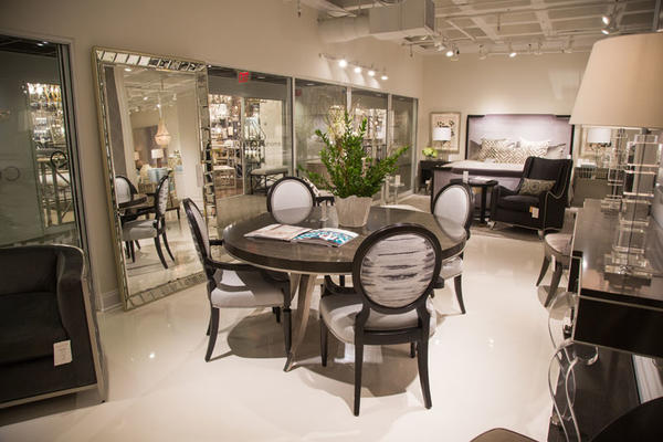 Custom Caracole couture product selections were featured in the Caracole showroom; shown here are customized Chit-Chat arm chairs surrounding the Table Dance table.