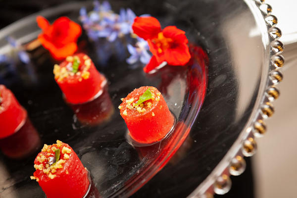Guests snacked on watermelon cylinders with aged balsamic gel, fennel crystals and micro basil.