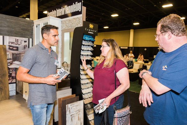 An attendee discusses samples in the Cambria booth.