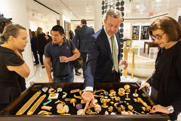 Abby Goodman and Thomas Zhuang (left) admire the artistic gilt hardware on display.
