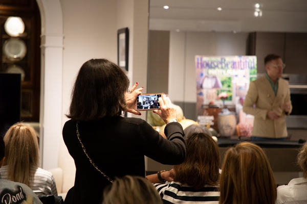 An attendee snaps a photo of Ross's presentation.