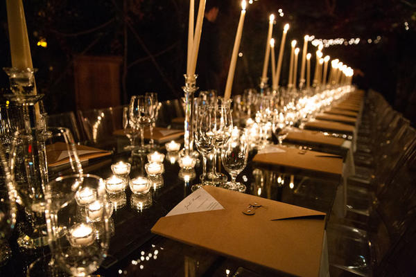 Guests dined at long, candle-lit tables.