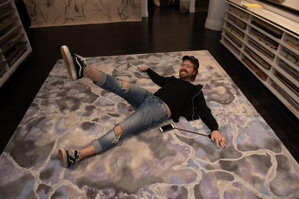 Dylan Kruse of Rockwell Group tests out a rug’s comfort factor—it’s a winner!