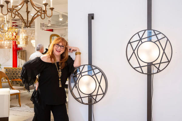 Robin Baron poses with her new Icon Sconce