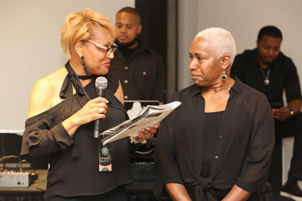 BIDN executive board member Joan Goodwin presents Curated Home Brands president Katrena Griggs with the Kimberly E. Ward 2019 Design Icon Award.