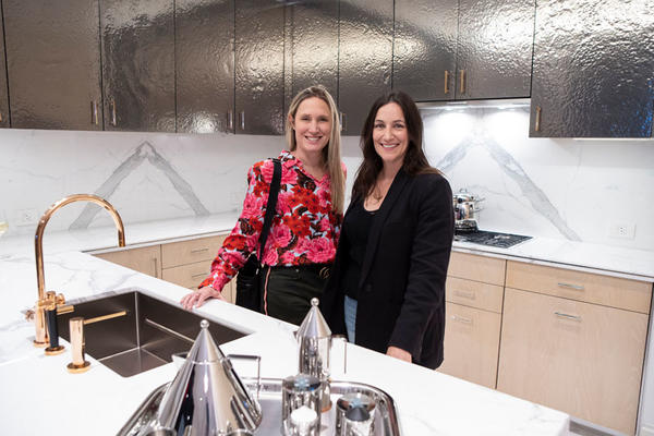 Jane Francisco and Laurie Jennings in the kitchen scheme with hammered metal upper cabinets