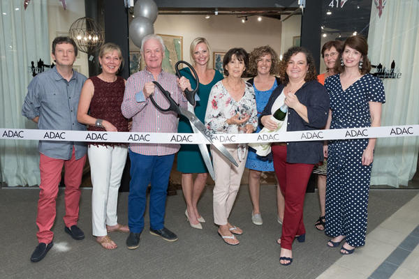 A ribbon cutting at the opening party for  Englishman’s Fine Furnishings