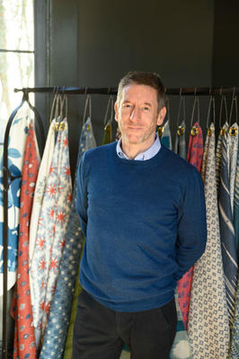 Peter Dunham in front of his namesake textile collection