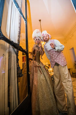 Guests posed with two costumed stilt walkers.
