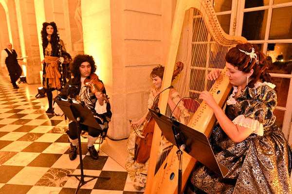 A Baroque musical trio played period instruments.