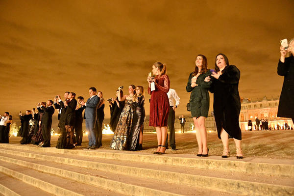 Guests gathered on the steps to watch a fireworks show over the Gardens of Versailles.