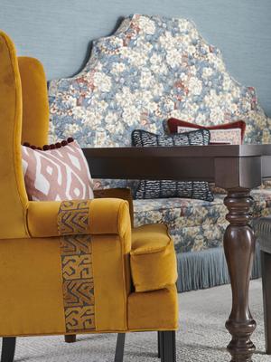Chair: Bohemian Velvet in Amber Gold and Mala trim in Saffron. Pillow: Kuba Maze fabric in Coral Clay and Sugarbath trim in Begonia. Wallcoverings:  50300W Sorbus in Jade 03. Settee: Peafowl fabric in Coral Clay and Excellence trim in Mineral. Pillows: Safiya Stripe fabric and Oolong trim in Jungle; Bohemian Velvet with Chondo trim in Pottery Mix and Oolong trim in Wicker