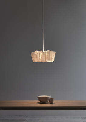 The Anders light is sculpted from layers of banana fiber, which is draped and stitched around the central light. 