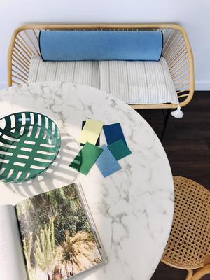 A bench seat cushion upholstered in Ultrasuede Lake, with Ultrasuede Cerulean piping, by interior design blogger Cassandra Lavalle of Coco Kelley