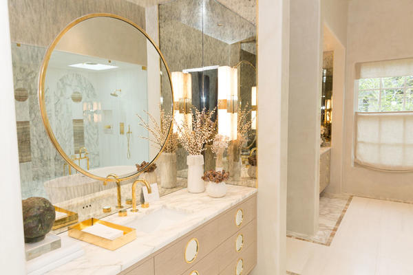The master bathroom features tile by Source, cabinetry by Karpaty, and stone by Ciot. 