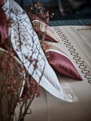 Links Embroidery duvet cover and sheet set in Amaryllis-Camel paired with coordinating Bold boudoir pillows.