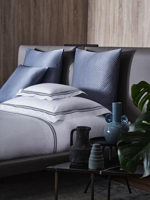 Triplo Bourdon duvet cover and sheet set in White-Dark Azure paired with Luxury Herringbone euro pillows in Dark Azure.
