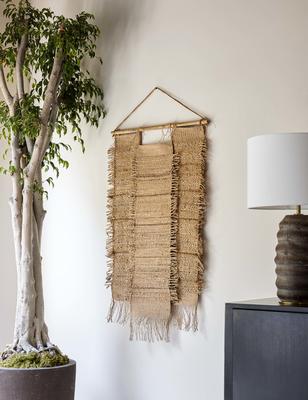 Woven with natural jute and hemp fibers, the Ukiah wall hanging is the perfect textured accent for a refined space. Its broad design spreads out rather than up making this the ideal wall decor to add a significant amount of artisanal texture to a living space like a bedroom or living room.
