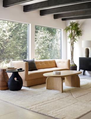 The Maleena rug stylized with the Ezri leather sofa, Corso side table, Gem side table and Ada oval coffee table.