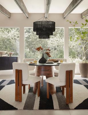 Hidara rug styled with the Sydney armless dining chair, Alder dining table, and Chavette chandelier.