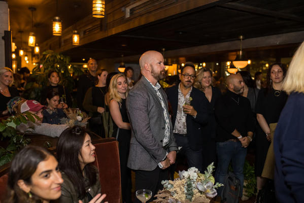 Guests gather for remarks from Elle Decor editor in chief Asad Syrkett.